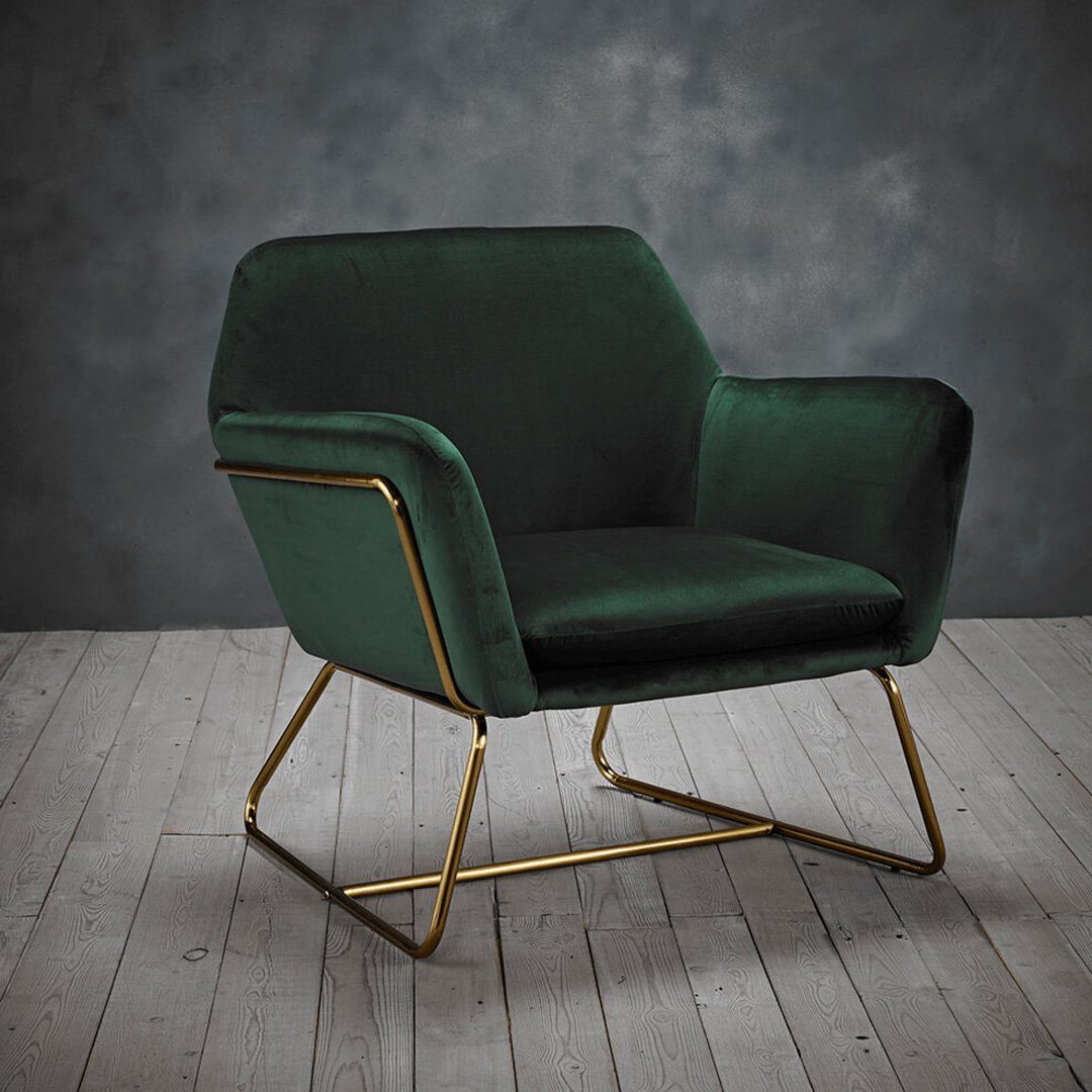 Lifestyle shot of the Charlie Armchair against a classy dark background