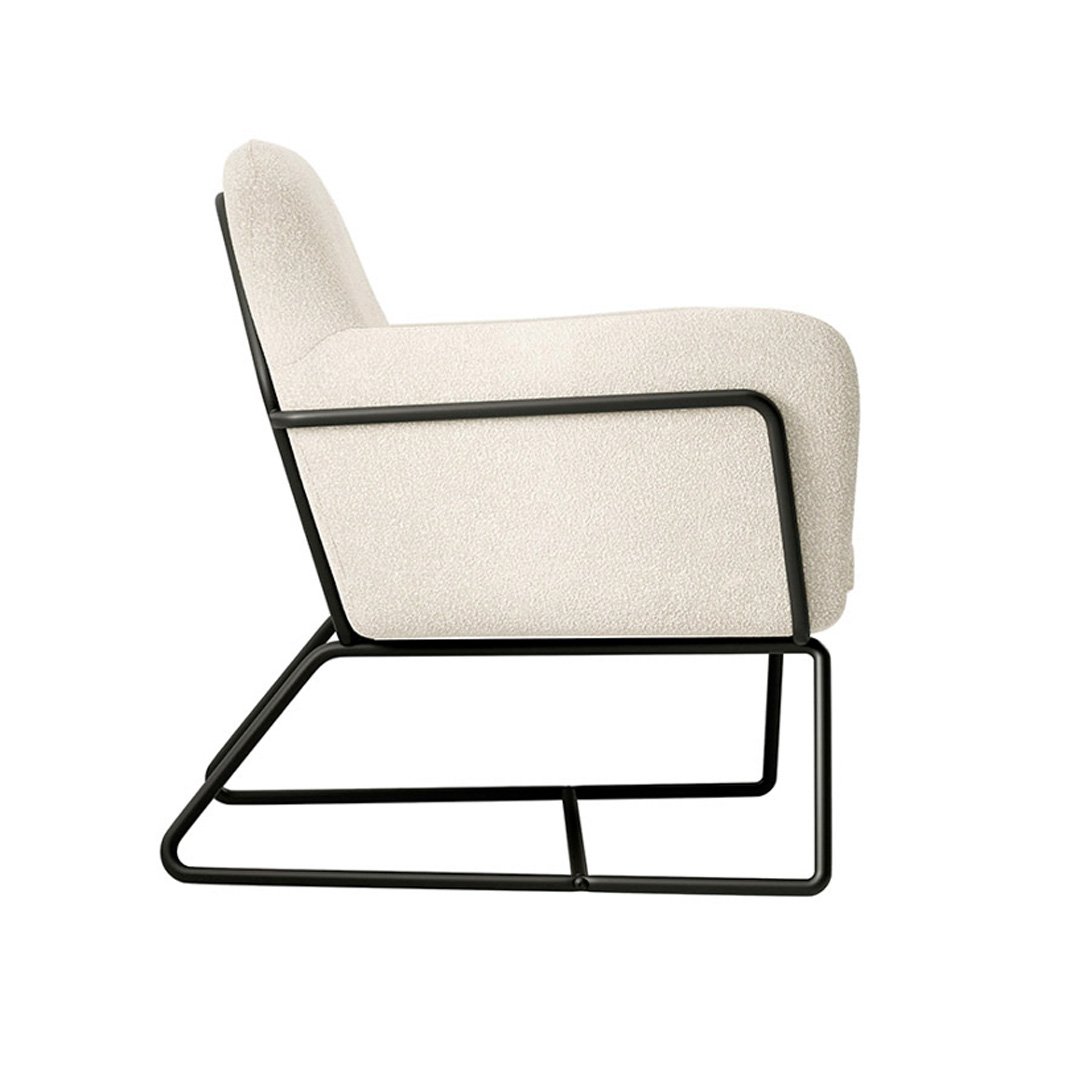 Side view of the armchair highlighting its ergonomic seat and design