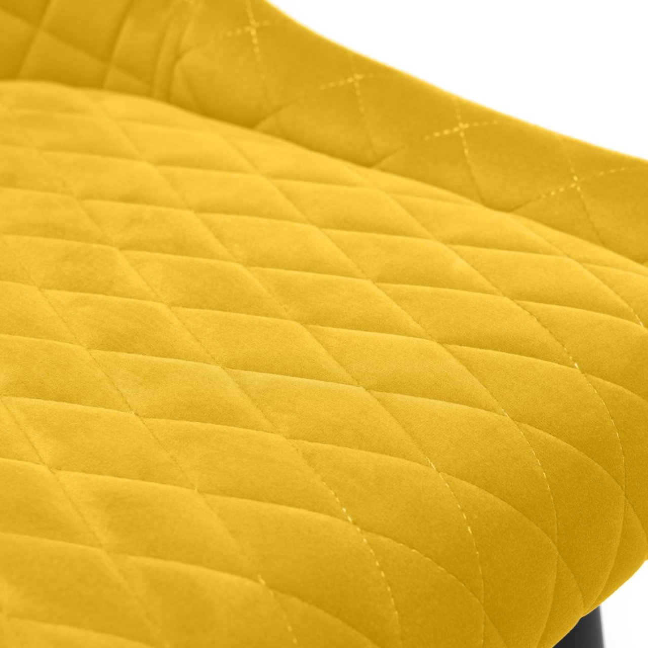 Focus on the seat upholstery of the bar stool and the quilted stitching creating rhomboid shapes in the design