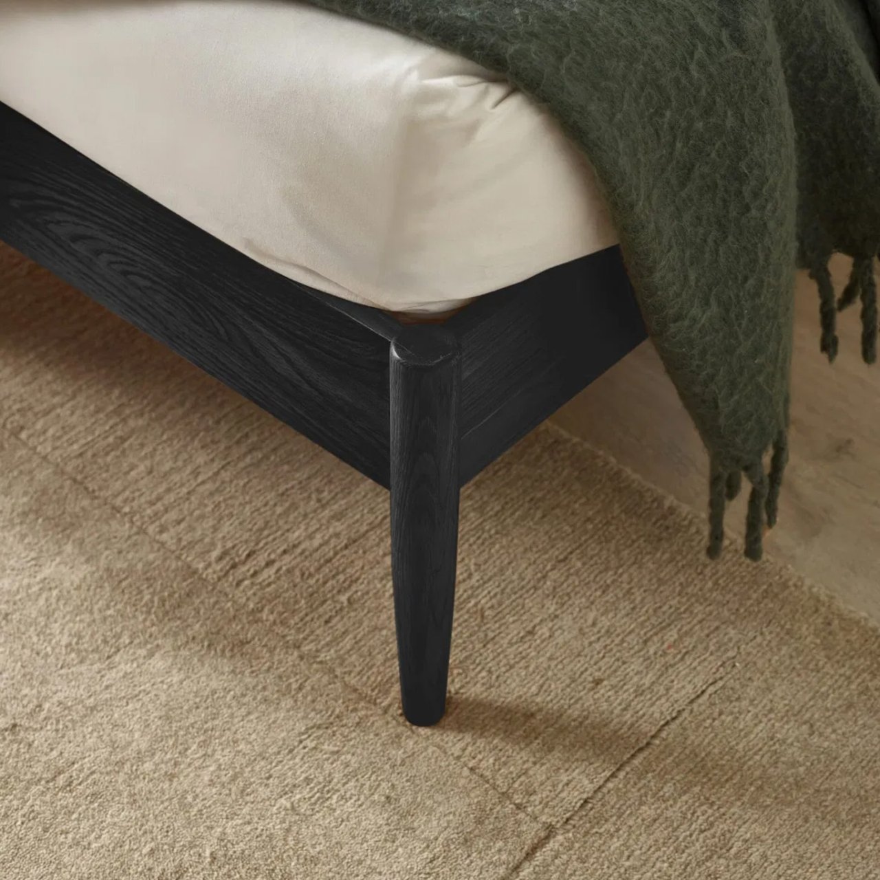 view of the round tapered leg of the bed