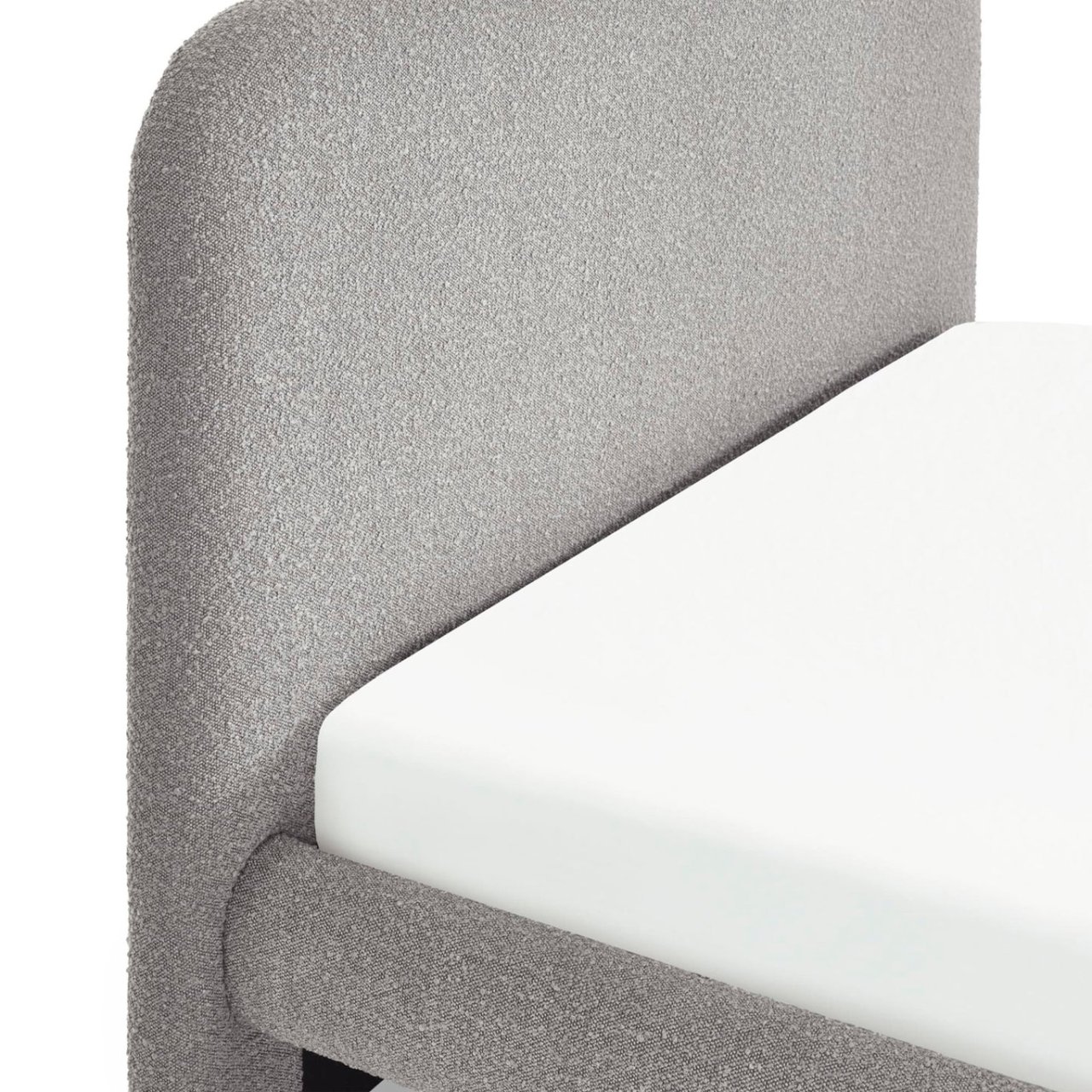 Focus on the headboard and side of bed showcasing the soft boucle fabric upholstering the bed