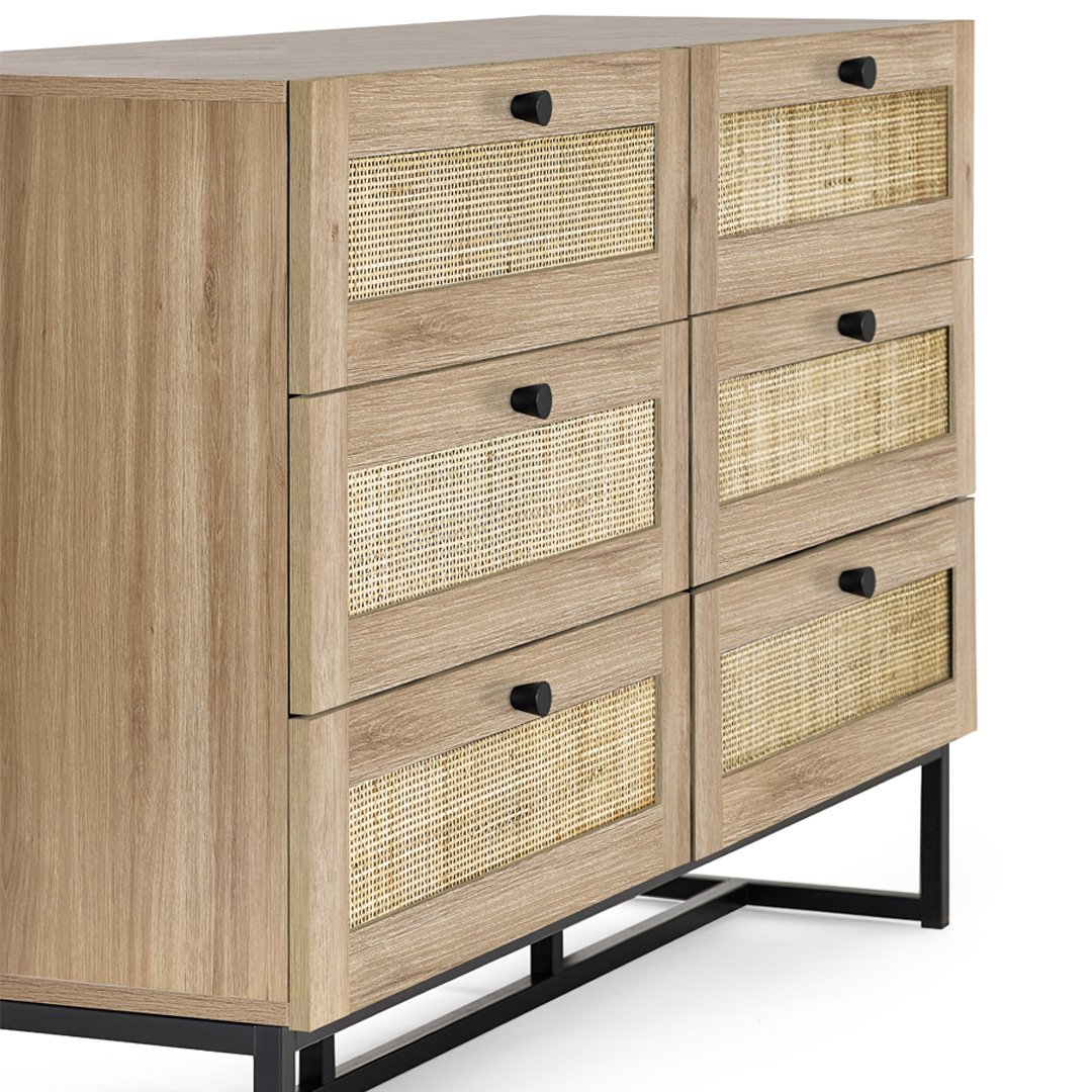 Side view of the Padre 6 drawer chest in oak showing the round black handles and the depth of the piece