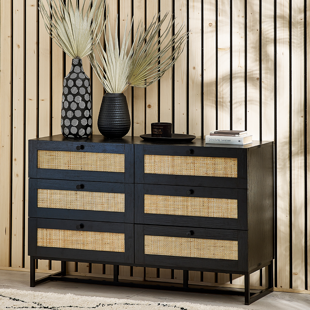 Lifestyle shot of the Drawer chest with decorations on top in a room with wood and oak details