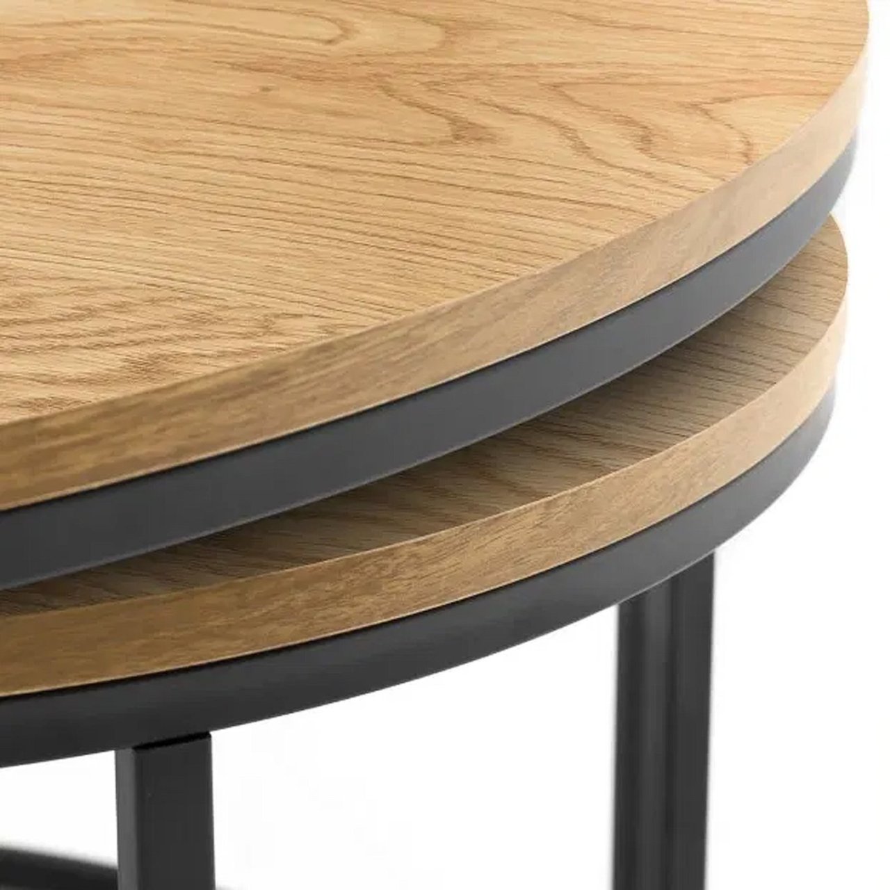 Close up of the two coffee table snugly fit together with the oak top and black metal legs on display