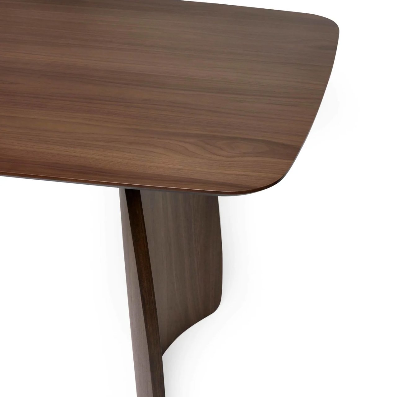 Different angle of the walnut dining table showcasing the plentiful surface of the tabletop and the stable leg