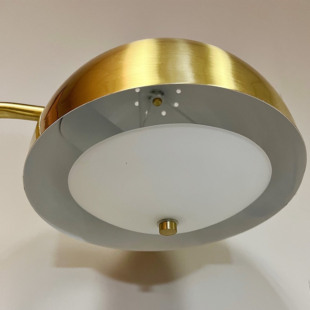View of the inside of the floor lamp's shade showing the bulb socket and inner shade