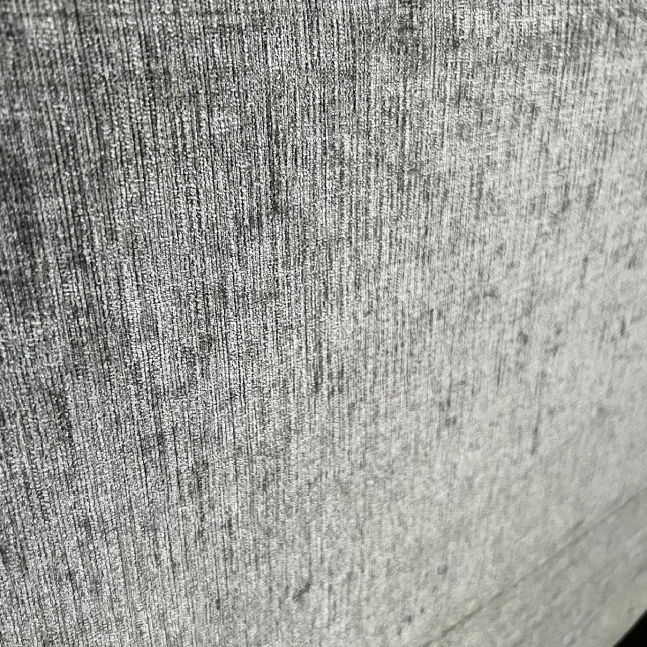 Zoom in on the chenille fabric of the upholstery and its grey colour