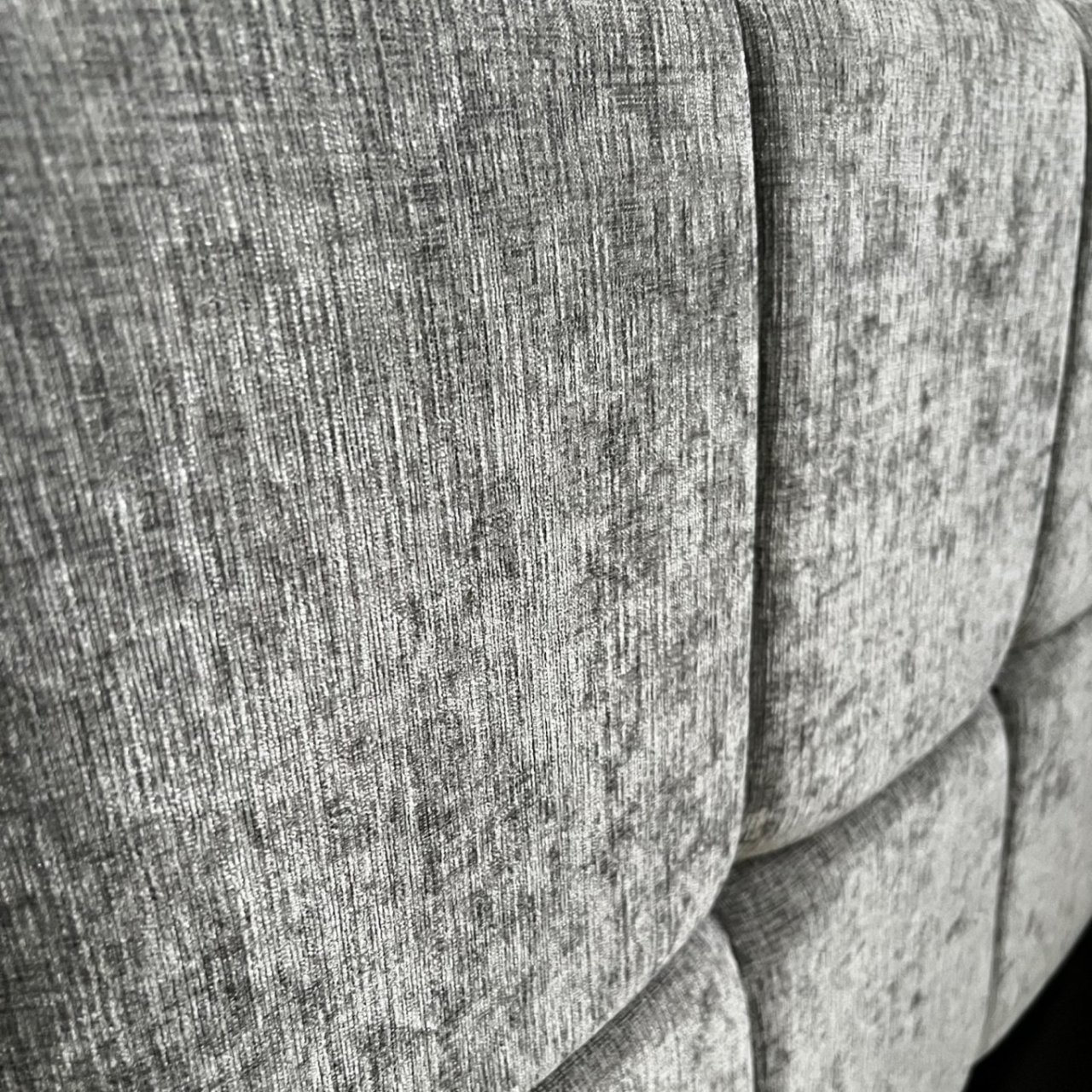Close up of the chenille fabric of the headboard in grey steel like colour