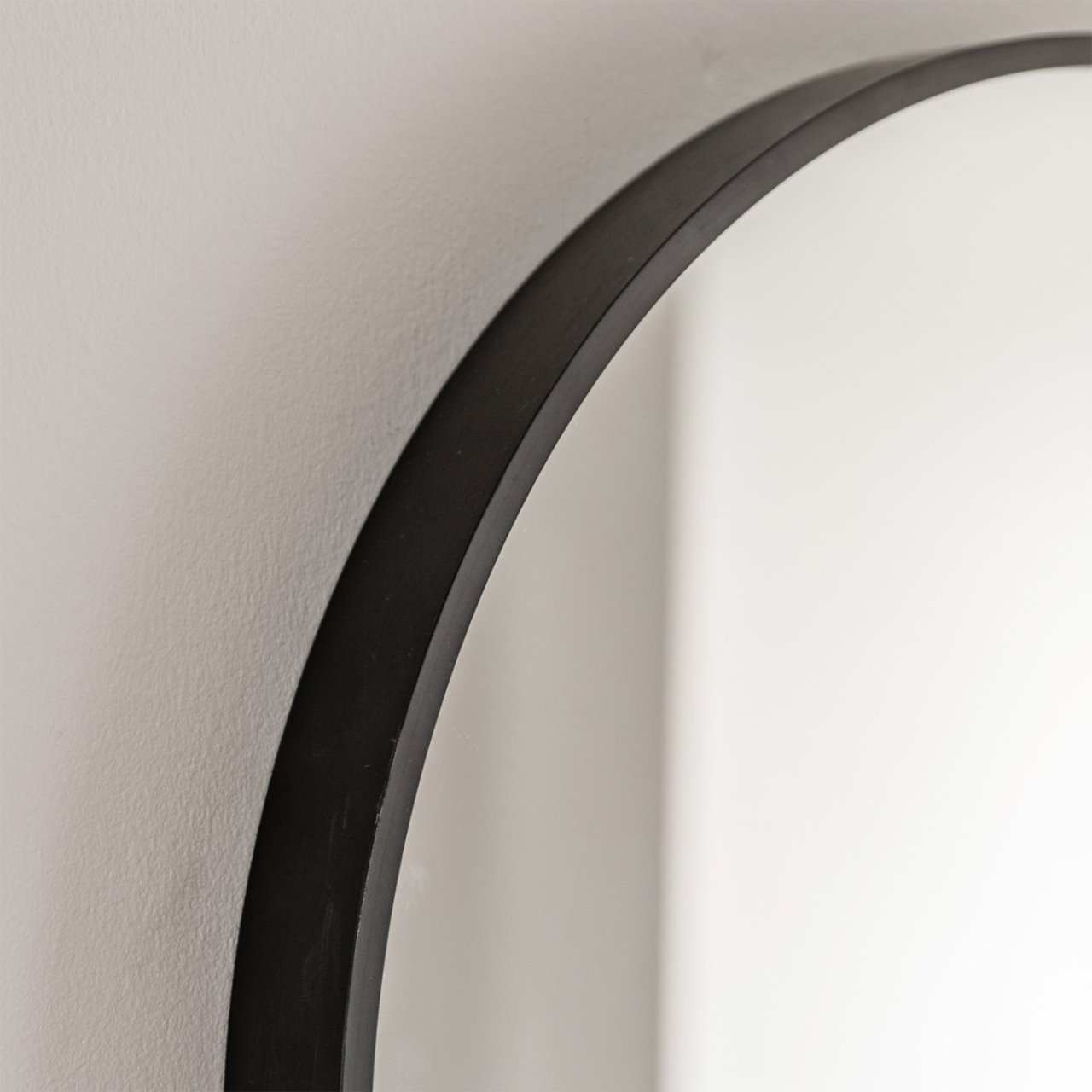 Zoom in on the sleek black frame which surround the mirror