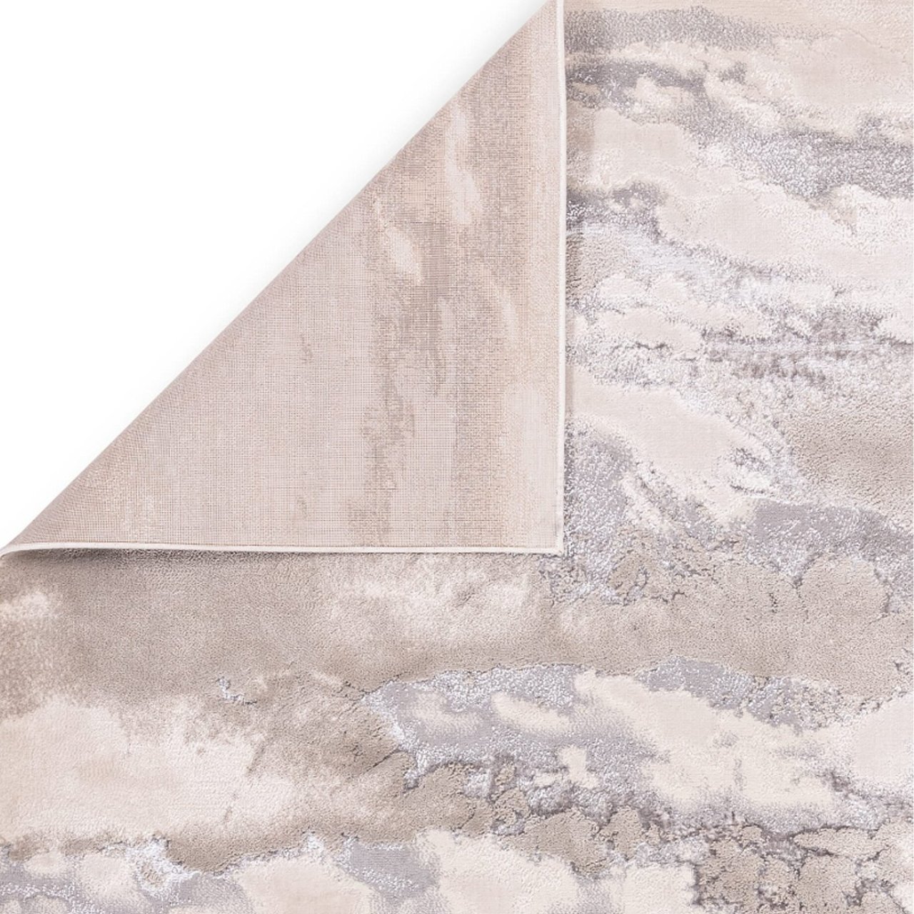 The aura rug with a corner folded inward to reveal the bound edges and the tough, robust fabric at the bottom of it