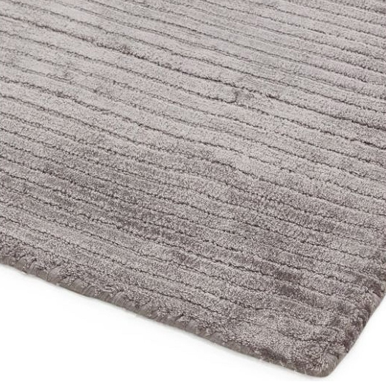 Corner view of the Bellamy grey rug showing the viscose fabric and the soft top