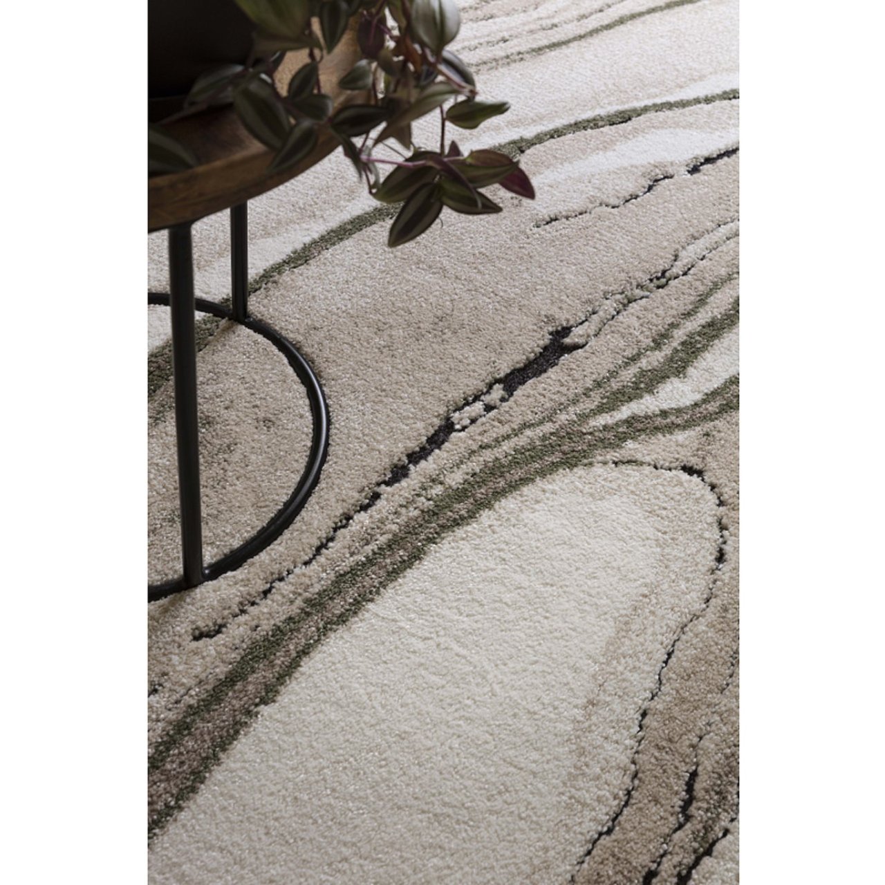 A rug with marbling effect and thick pile height sitting under a round coffee table