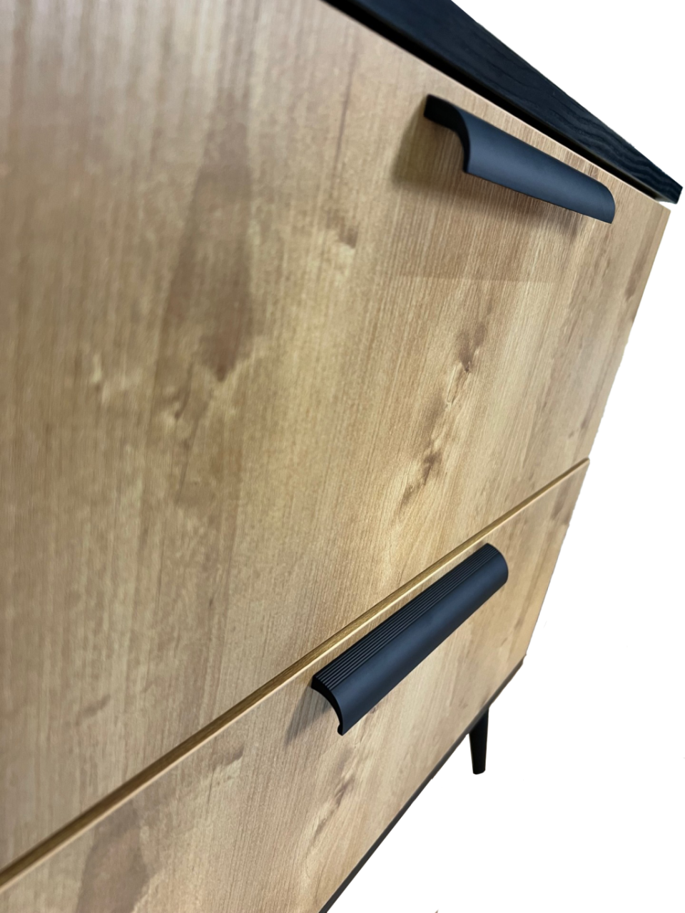 Focus on the sideboard's drawers and particularly its handles which curve downward and become narrower towards the tip