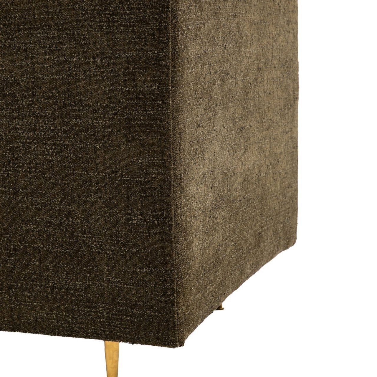 Zoom in on the fabric on the back of the sofa with the gold metal leg in view as well