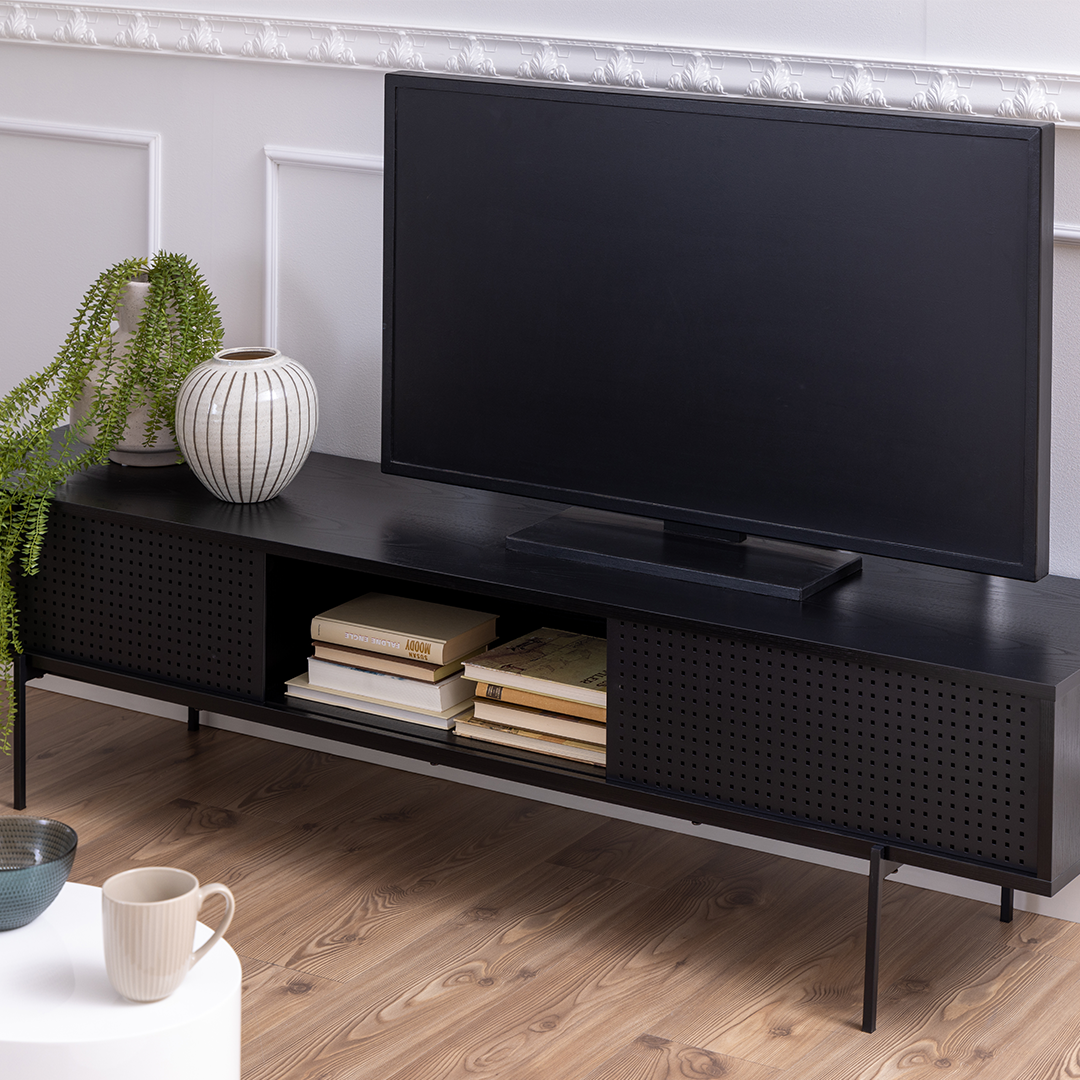 Closer lifestyle shot showcasing the ability of the TV unit to hold multiple items on its top