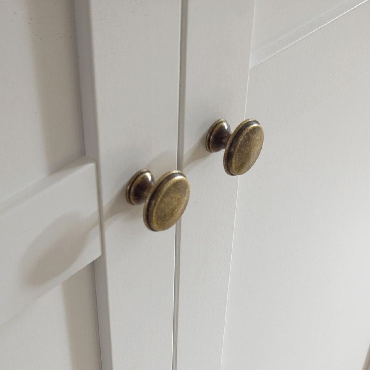 Zoom in on the round , brass colour metal handles.