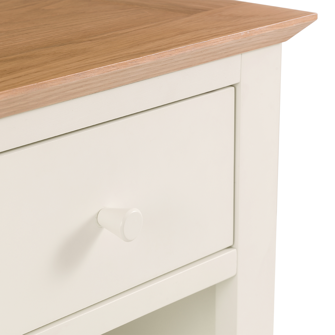 Closeup of the top drawer of the bedside as well as the oak finish of the top