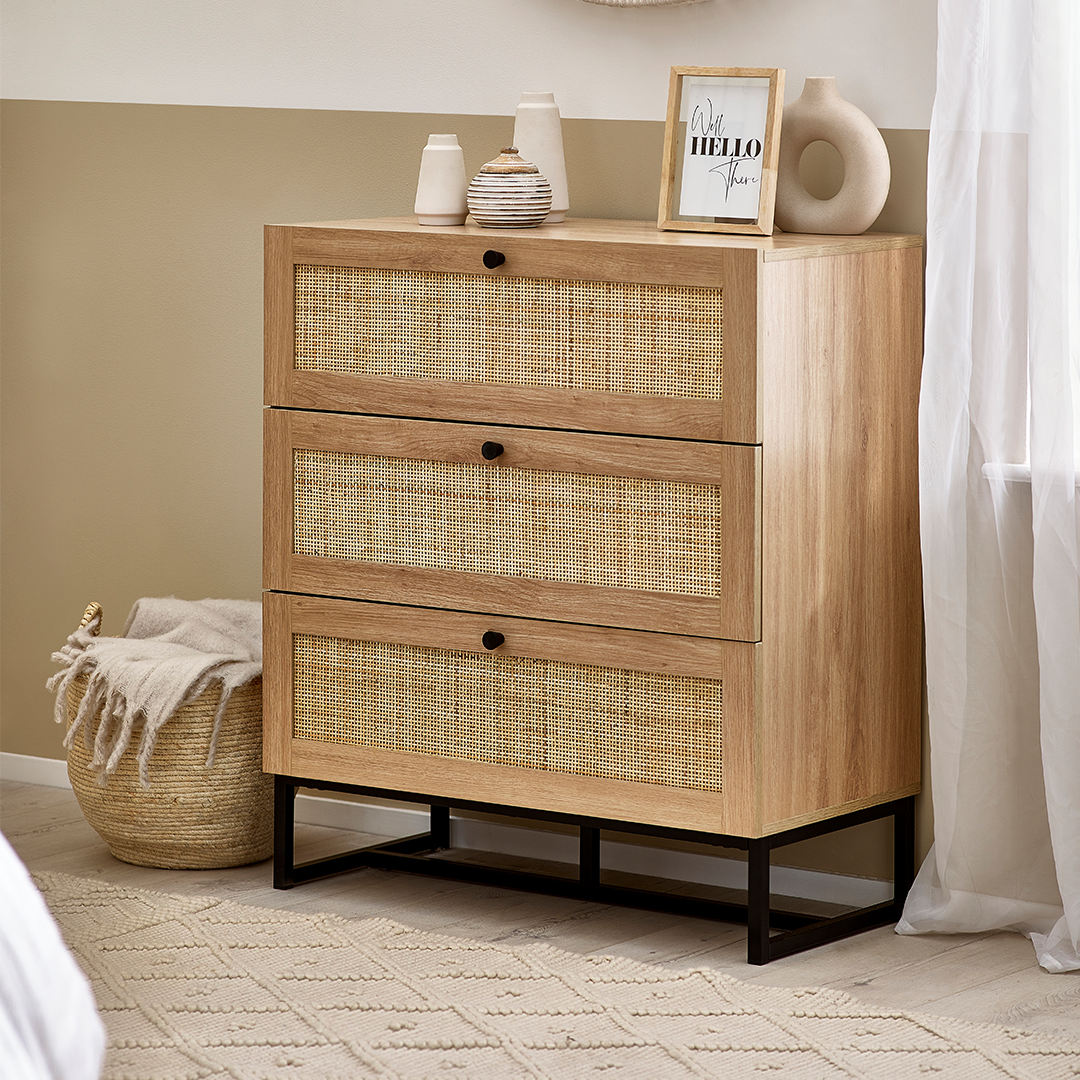 Lifestyle shot of the chest of  drawers in a light, breezy bedroom