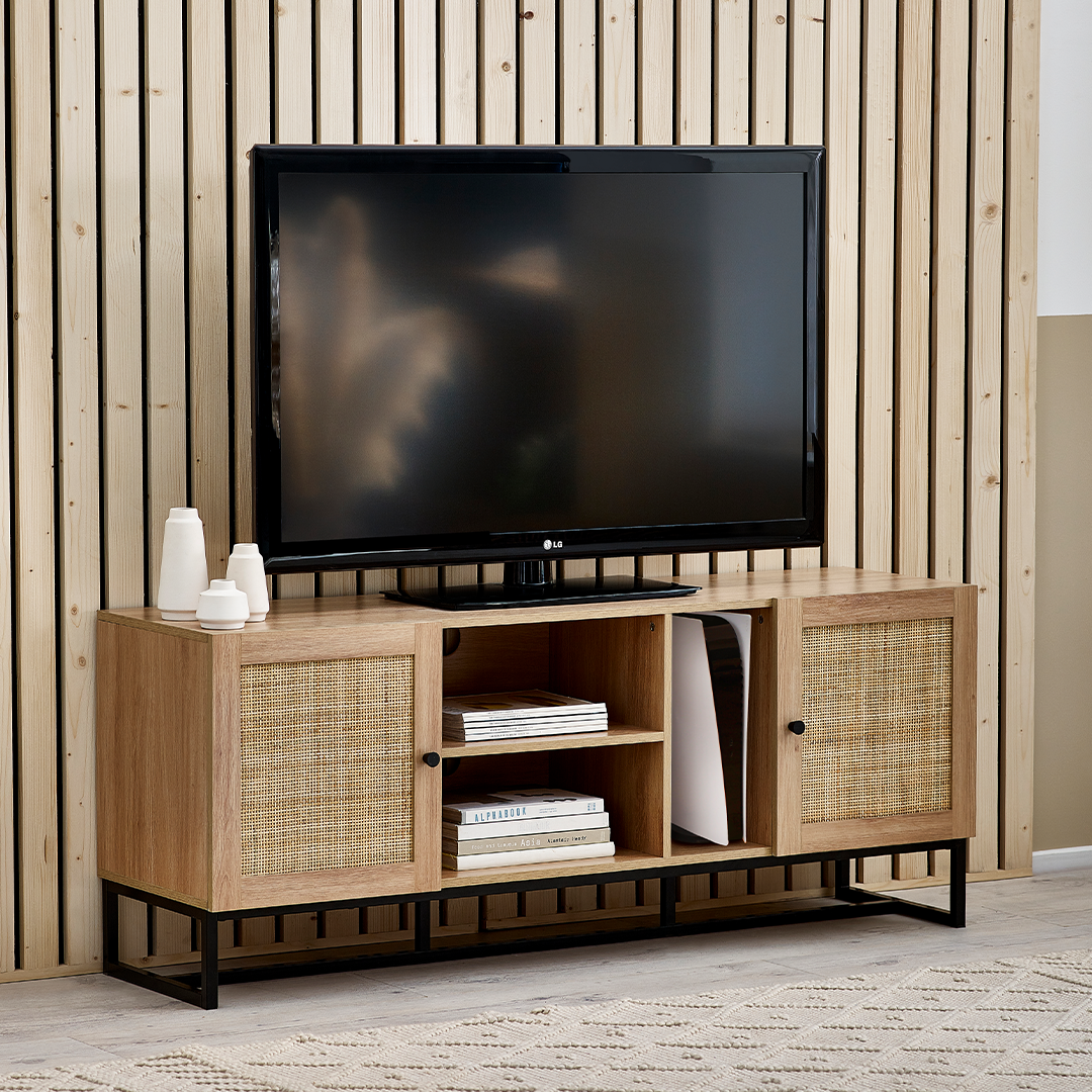 Lifestyle shot of the TV Unit showcasing a TV on top with a gaming console and books on the shelves